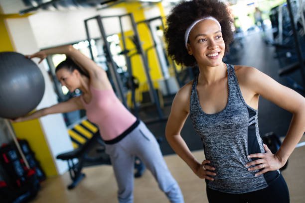 istock Group of young people doing exercises in gym 1171660587