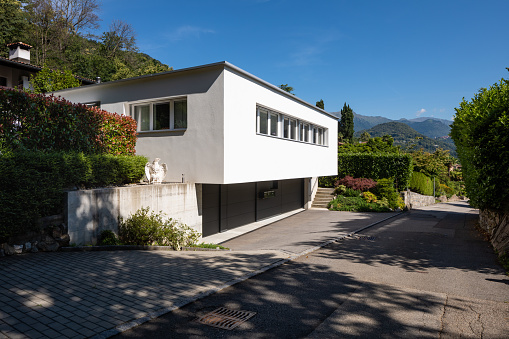 Smal modern white house in Switzerland, it is very romantic situation, long windows.