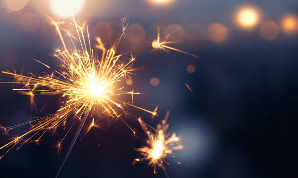 istock Glittering burning sparkler against blurred bokeh light background 1171665671