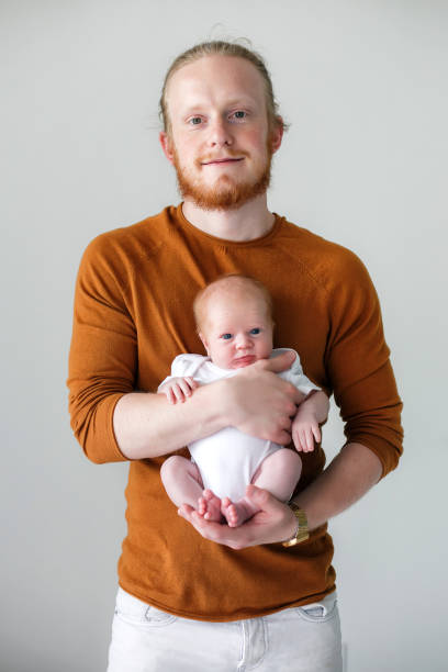 istock Young father holds a newborn son in his arms 1171670350