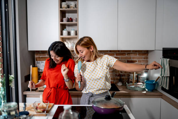 istock Two female friends having fun and making a meal 1171670506