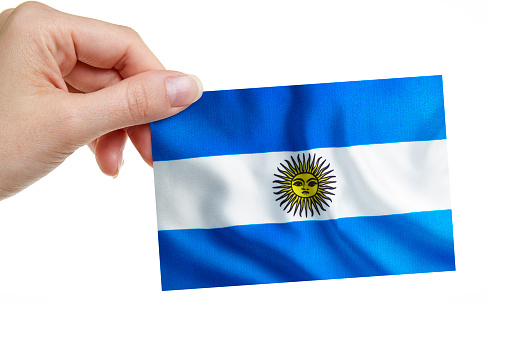 A woman is holding the Argentinian Flag on white background