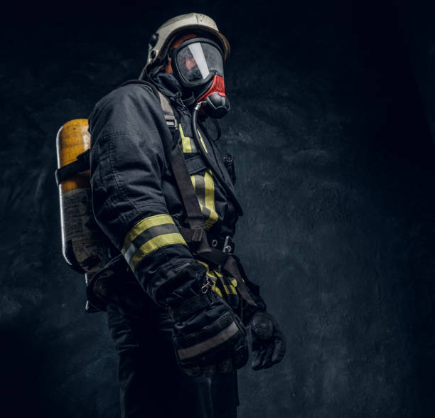 istock Firefighter in safety helmet and oxygen mask wearing protective clothes. 1171675099