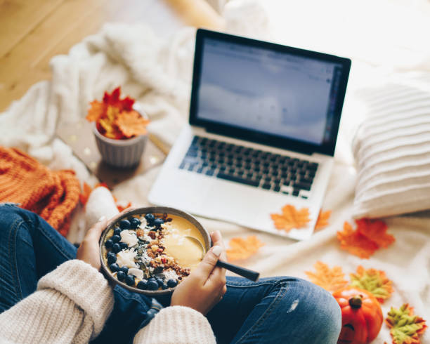 istock Woman having healthy breakfast and using laptop - Autumn concept 1171675740