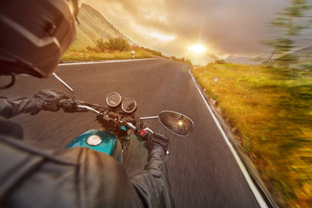 istock Motorcycle driver riding in Alpine highway, handlebars view, Dolomites, Europe. 1171675745