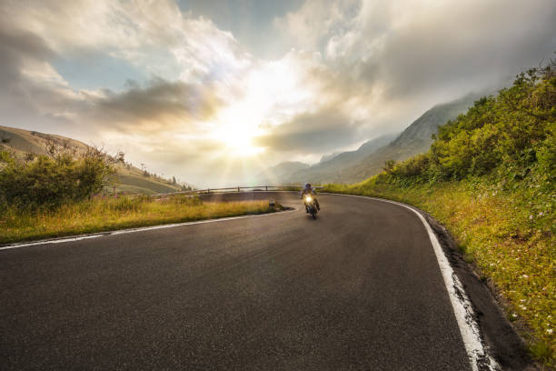 istock Motorcycle driver riding in Dolomite pass, Italy, Europe. 1171675810