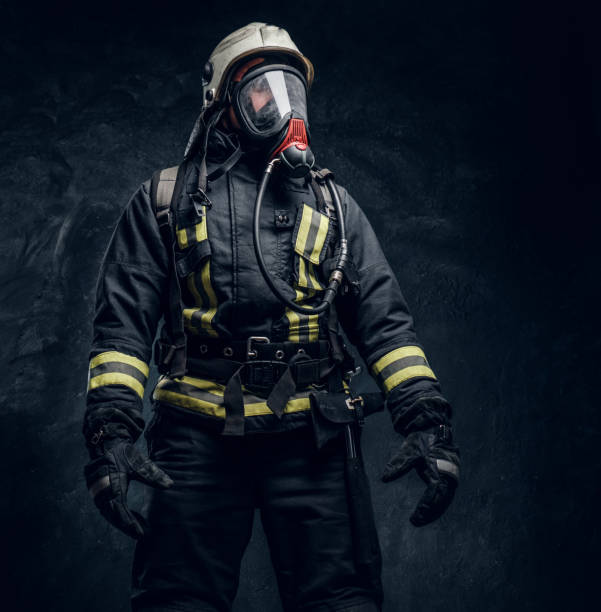 istock Firefighter in safety helmet and oxygen mask wearing protective clothes. 1171675946