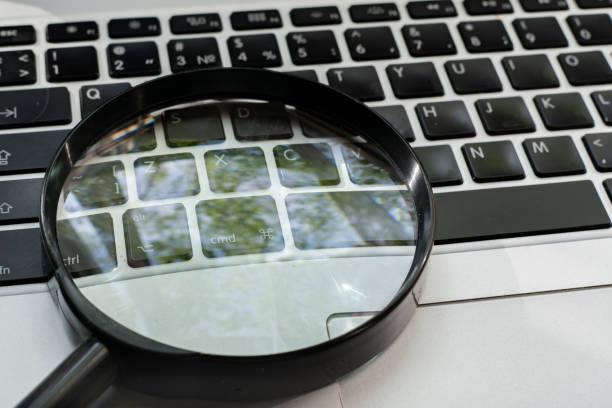 istock a magnifying glass on the keyboard, searching on the internet concept 1171676350