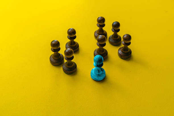 istock a unique chess pawn in color. leadership concept on a chessboard between other pieces 1171676521