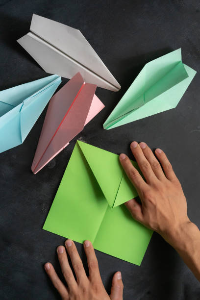istock person hands making a origami color paper plane 1171676524