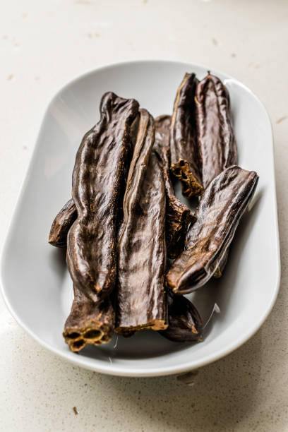 istock Ripe Carob Pods in Plate Ready to Eat. 1171680056