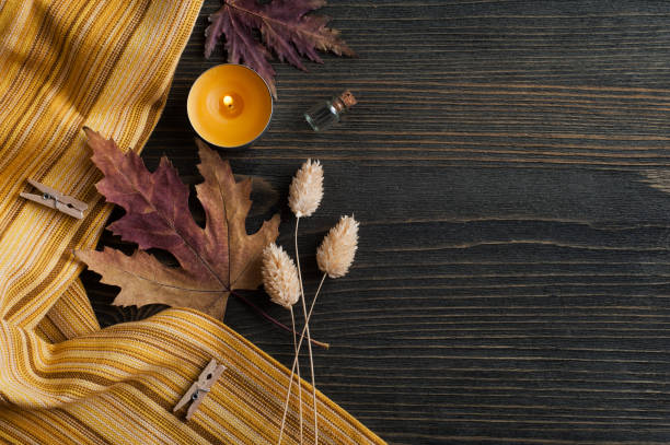istock autumnal leaves and lit candles 1171681840
