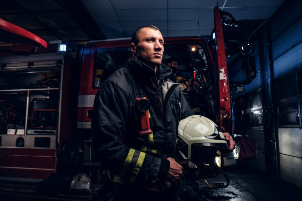 istock The fire brigade came to the call at night. Handsome fireman wearing a protective uniform with a flashlight included 1171681935