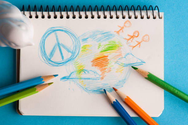 istock Notepad with color pencils and child drawing 1171682193