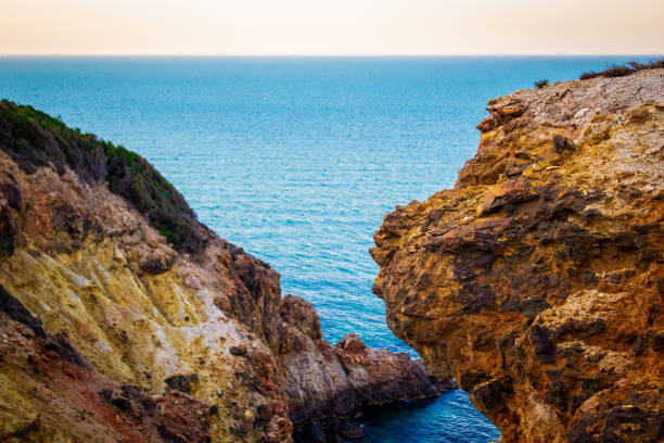 Exotic cliff rock, background sea Light brown color rocks and cliff, waves hitting the rocks lagün stock pictures, royalty-free photos & images