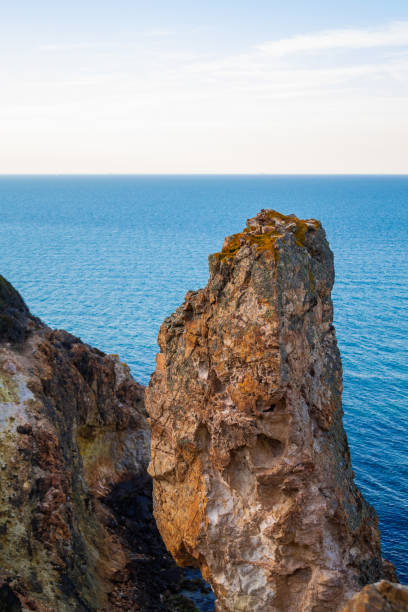 Exotic cliff rock, background sea Light brown color rocks and cliff, waves hitting the rocks lagün stock pictures, royalty-free photos & images