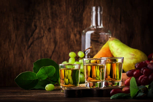 rakija, raki or rakia - balkan hard alcoholic drink or brandy from fermented fruits, old wooden table, still life, copy space - slivovitz imagens e fotografias de stock