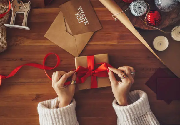 Photo of Woman wrapping a Christmas present