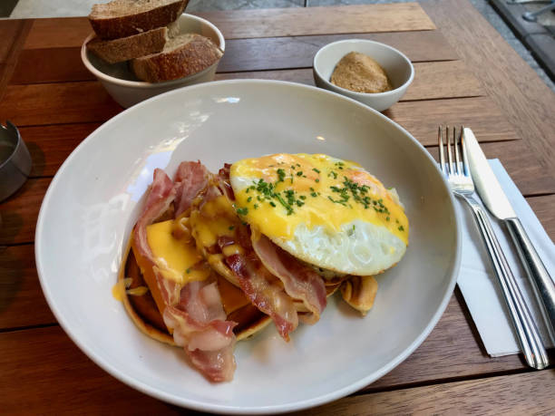 istock Salty Pancakes with Hollandaise Sauce, Melted Cheddar Cheese, Eggs and Crispy Bacon for Breakfast. Salted Food. 1171685865