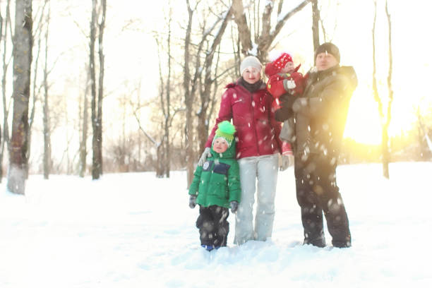istock Young family in winter park 1171689062