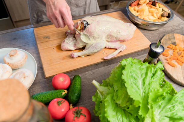 istock Close-up of female hands preparing duck or goose for baking. 1171689251