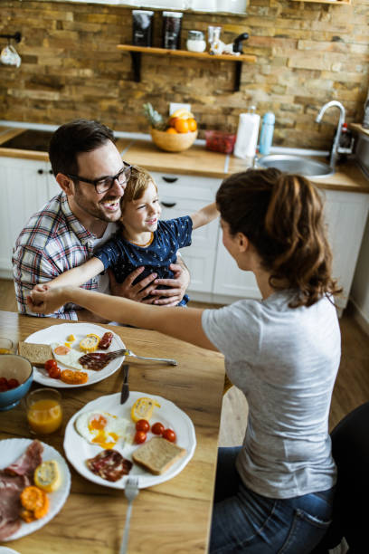 istock Above view of happy family having fun during breakfast in dining room. 1171690708