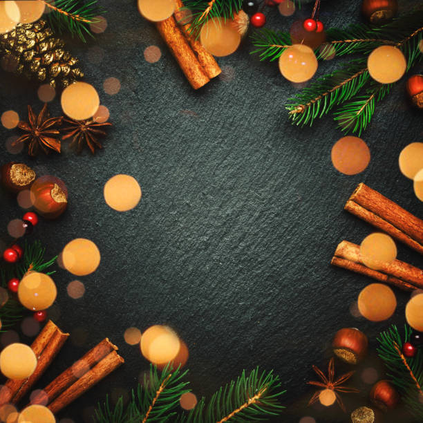 istock Christmas or New Year dark background, frame, template, with festive decorations, winter spices and Christmas decorations, nuts and fir branches, top view 1171690736