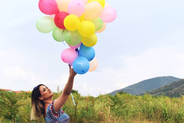 istock Girl holding balloons 1171691123