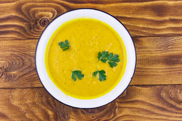 istock Pumpkin soup on a wooden table. Top view 1171693249