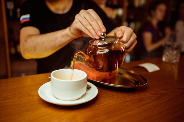 istock Process brewing tea,tea ceremony,Cup of freshly brewed black tea,warm soft light, darker background. 1171693520