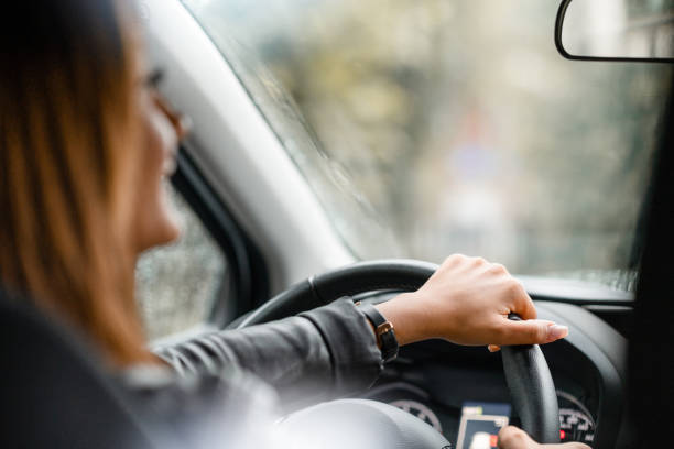 istock Female taxi driver is looking back through the rear view mirror 1171694178