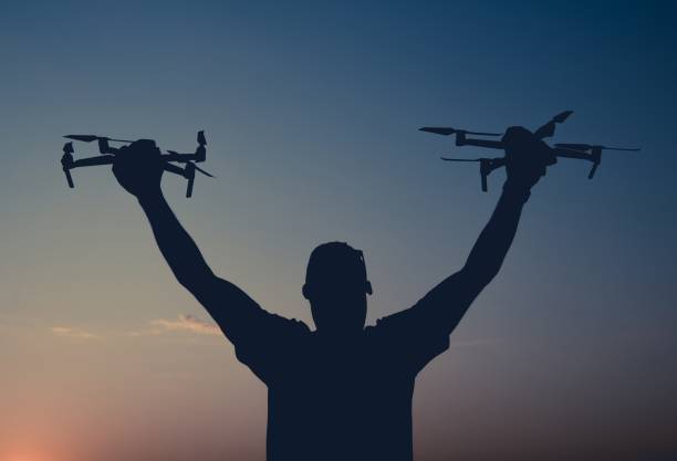 Master Drone Operator Master Aerial Photographer with Two Modern Drones in Hands. Commercial and Recreational Aircrafts Flighting. hobbyist stock pictures, royalty-free photos & images