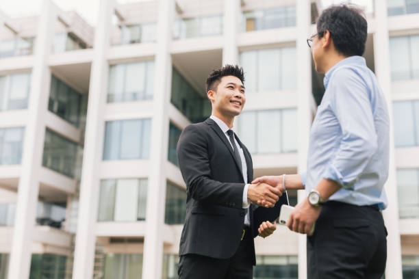 istock Two satisfied Asian businessmen shaking hands. 1171696352