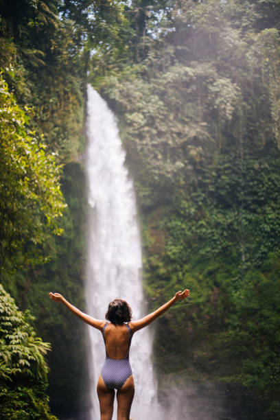 istock Woman looking at the waterfall in jungles 1171698801
