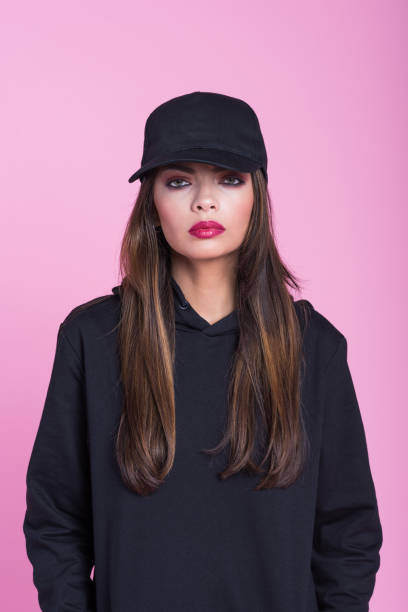 istock Cofident young woman in black clothes against pink background 1171700311