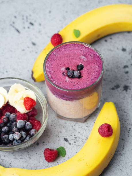 istock double-layered cocktail smoothie with banana, blueberries and raspberries 1171700580