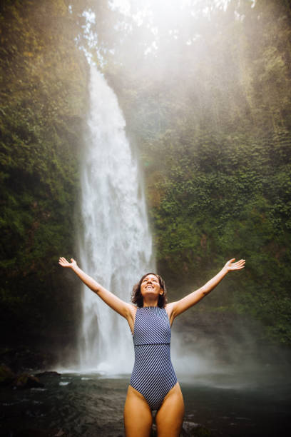 istock Woman looking at the waterfall in jungles 1171700719