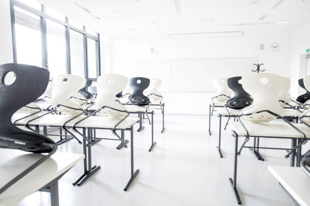 istock Contemporary Empty Classroom with White and Black Chairs 1171700786