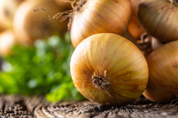 istock bundle of freely lying dried onion on a wooden table 1171700945