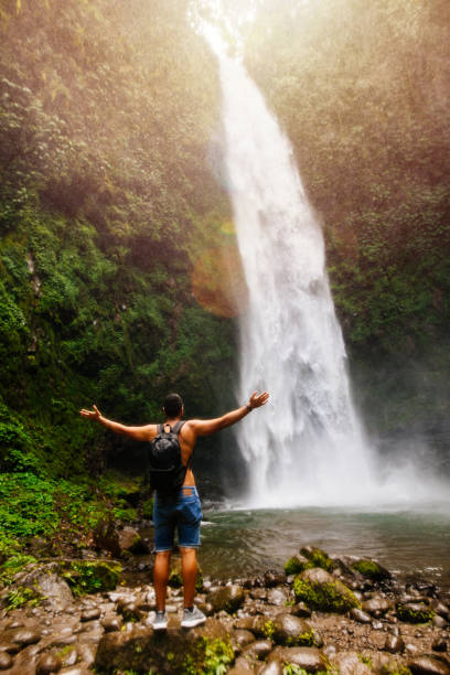 Male tourist enjoying near waterfall