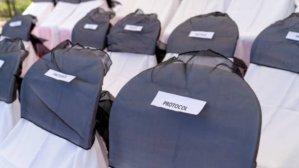 istock Reserved chairs in a row for protocol. Reserved chairs in a row for VIP. Chairs covered by white and grey cloth. 1171701116