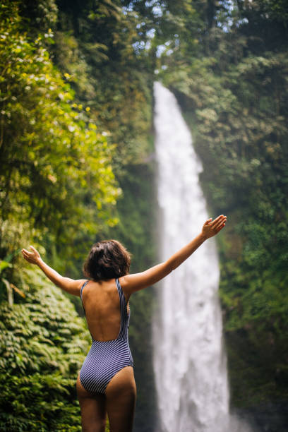 Woman looking at the waterfall in jungles