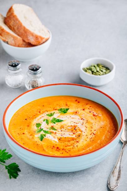 istock Carrot and pumpkin cream soup with parsley 1171703354