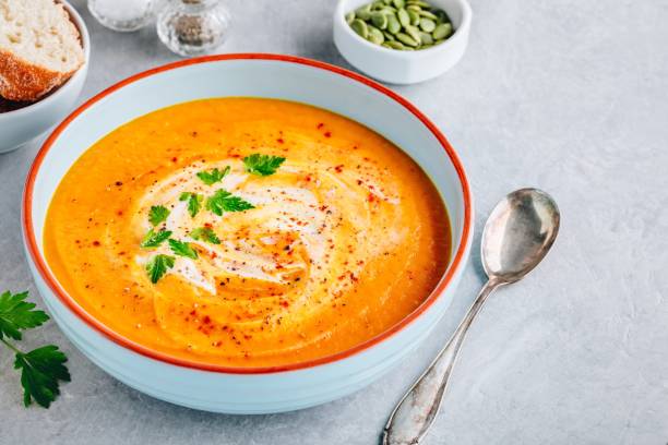 istock Carrot and pumpkin cream soup with parsley 1171703412