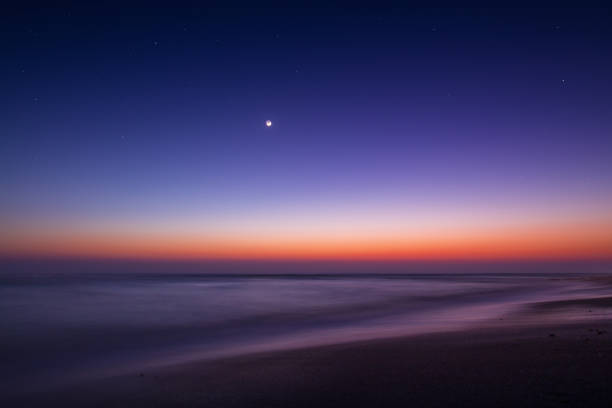 istock Long exposure on the beach one evening with the month before sunrise 1171704530