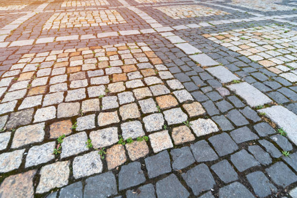 istock Old paving stones pattern. Texture of ancient german cobblestone in city downtown. Little granite tiles. Antique gray pavements. 1171704613