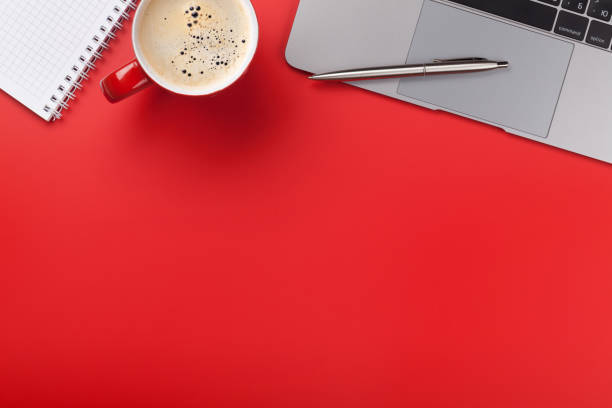 istock Office red workplace with coffee cup, supplies and computer 1171705781