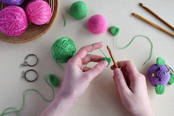 istock Making colored crochet bird. Toy for babies or trinket.  On the table threads, needles, hook, cotton yarn. Handmade gift. DIY crafts concept. 1171706513