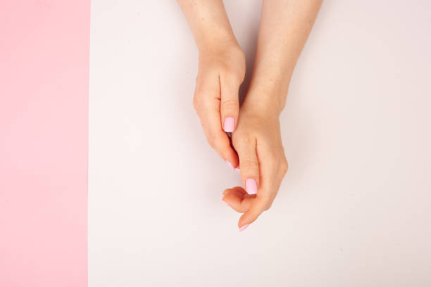 istock Hands with manicure on a combined double pink and white background with place for text. Flat lay 1171707073