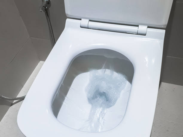 toilet, flushing water, flush toilet, closeup at toilet, white toilet - toilet public restroom bathroom flushing imagens e fotografias de stock